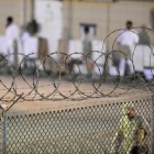 A Navy guard patrols JTF Guantanamo’s Camp Delta recreation yard.  Joint Task Force Guantanamo Flickr, 7/7/10.