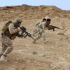 A U.S. Marine leads a group of Iraqi soldiers through a fire and maneuver course at Al Asad Air Base, Iraq [U.S. Marine Corps Photo by Cpl. Carson A. Gramley/ Released, 1/28/15]